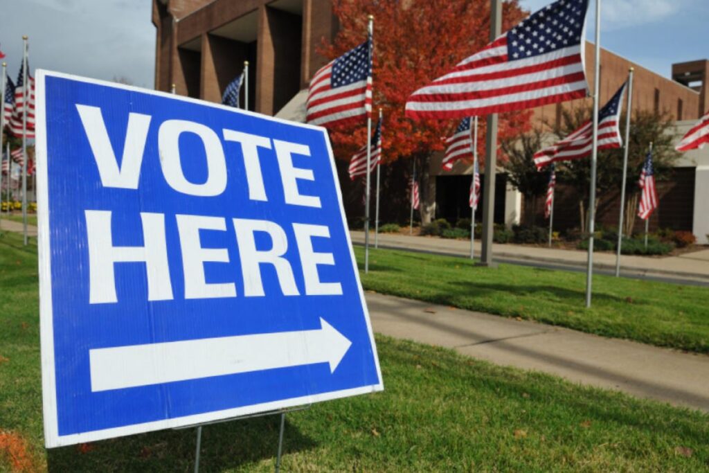 VOTE HERE sign outside of a polling place.